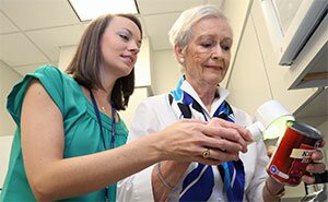 assisting a lady with viewing label on can